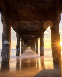 A pier with the sun setting in the background.